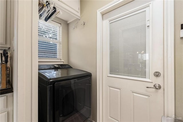 washroom featuring cabinet space and washer / dryer