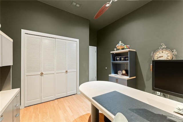 office space featuring light wood-type flooring, visible vents, and ceiling fan