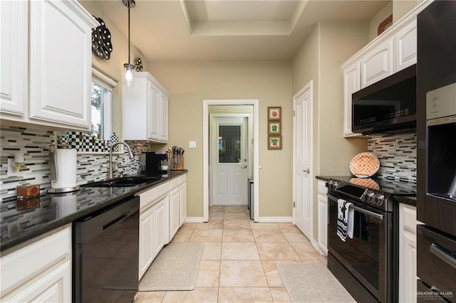 kitchen featuring light tile patterned flooring, a sink, range with electric cooktop, black dishwasher, and a raised ceiling