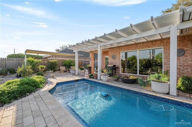 view of swimming pool with a fenced in pool, a patio, fence, and a pergola