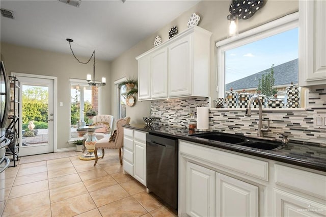 kitchen with dark countertops, visible vents, black dishwasher, light tile patterned floors, and a sink