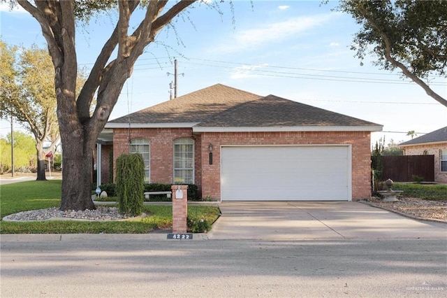 single story home featuring driveway, fence, roof with shingles, an attached garage, and brick siding