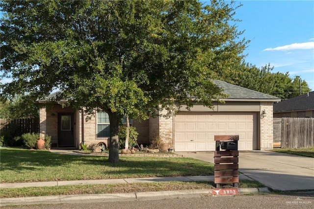 obstructed view of property with a front lawn and a garage