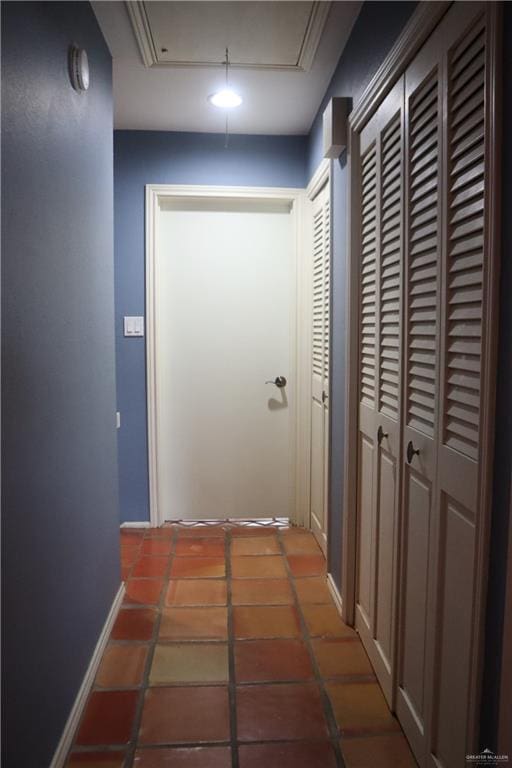 hallway with dark tile patterned floors