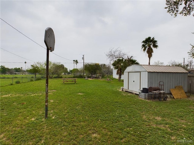 view of yard with an outdoor structure and fence