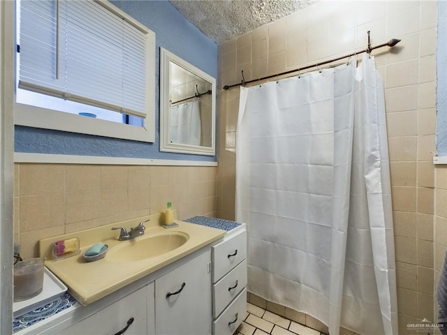 bathroom featuring tile walls, vanity, and tile patterned floors