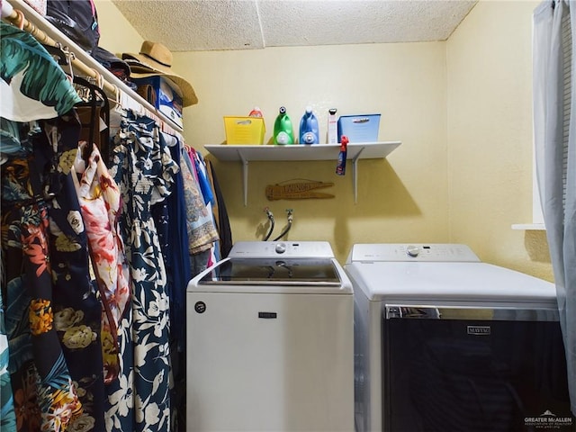 laundry area featuring a textured ceiling, laundry area, and separate washer and dryer