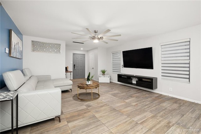 living room with ceiling fan and light hardwood / wood-style floors