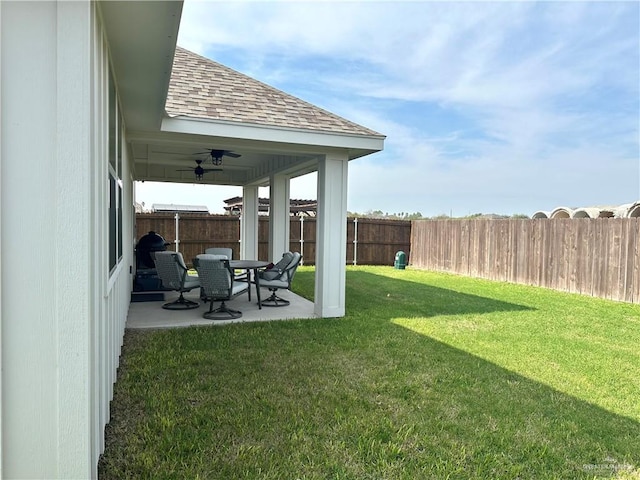 view of yard with a patio area, ceiling fan, and a fenced backyard