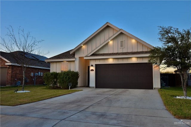 view of front of home with an attached garage, board and batten siding, concrete driveway, and a yard