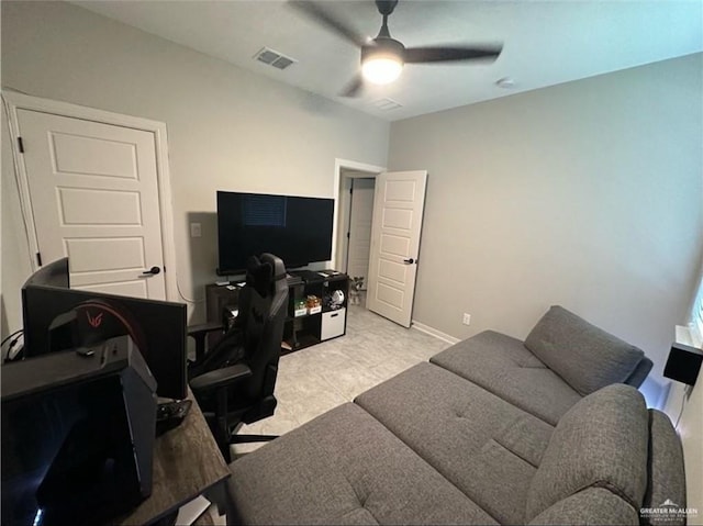 home office with a ceiling fan, visible vents, and baseboards