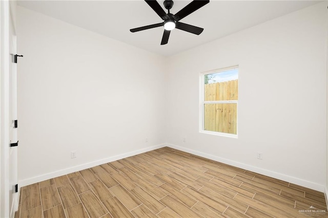 empty room with ceiling fan, baseboards, and light wood-style floors