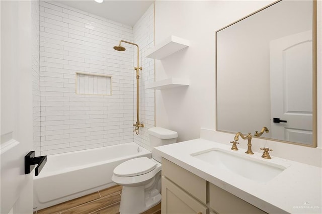 full bath with bathtub / shower combination, wood finished floors, vanity, and toilet