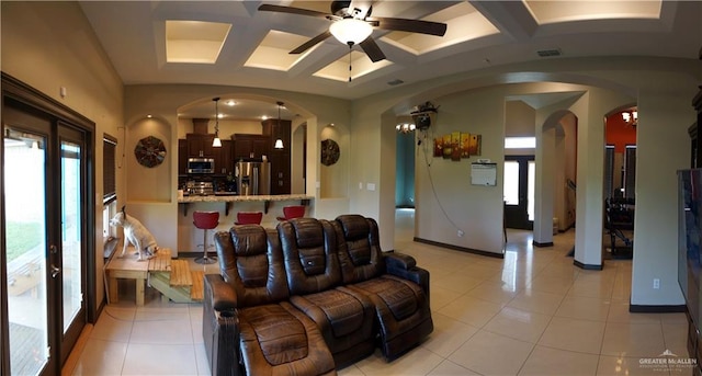 living room featuring beamed ceiling, light tile patterned floors, ceiling fan, and coffered ceiling