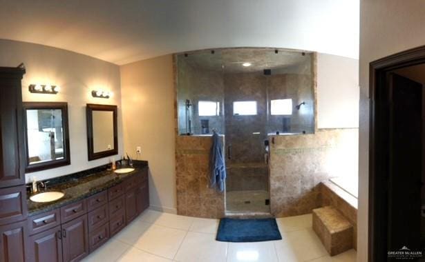 bathroom featuring a tile shower, vanity, and tile patterned floors