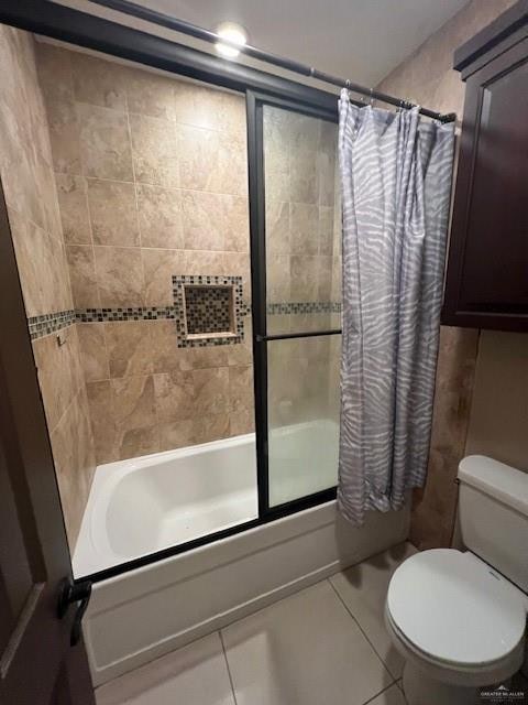 bathroom featuring tile patterned flooring, shower / tub combo, and toilet