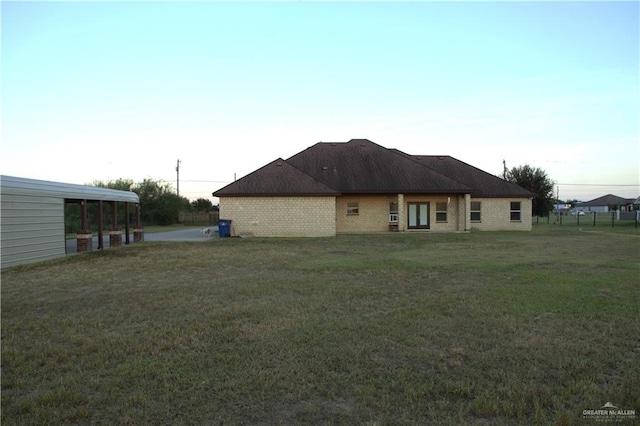 rear view of property featuring a yard