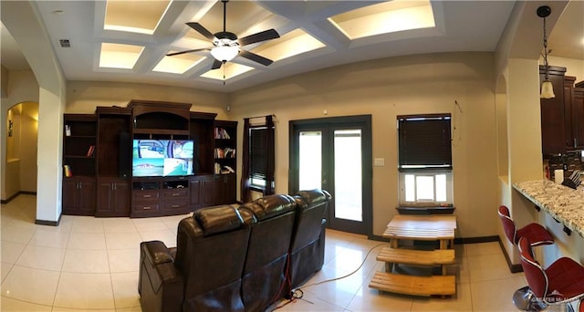 tiled living room with beam ceiling, ceiling fan, french doors, and coffered ceiling