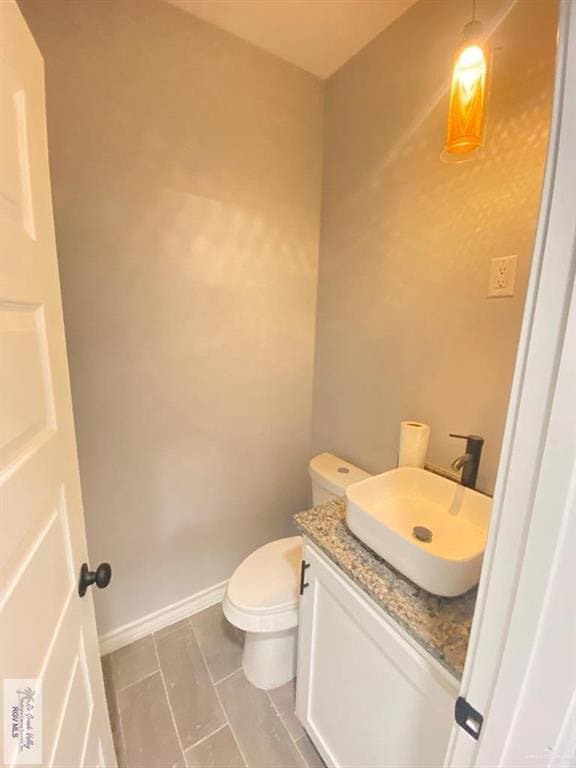 1271 Stirrup Cir, San Benito, TX 78586 - bathroom with vanity, toilet, tile patterned flooring, and baseboards