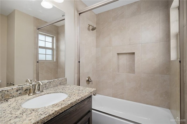 bathroom with vanity and tiled shower / bath