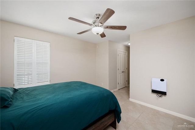 bedroom featuring ceiling fan, light tile patterned flooring, and heating unit