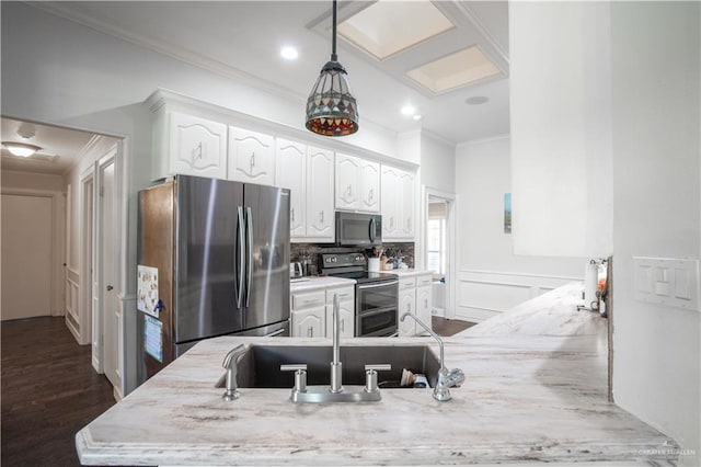 kitchen featuring white cabinetry, dark hardwood / wood-style flooring, ornamental molding, and appliances with stainless steel finishes