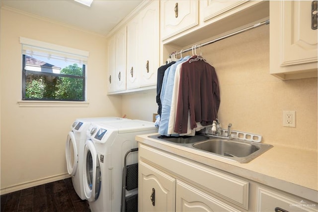 laundry area with sink, cabinets, dark hardwood / wood-style floors, crown molding, and washer and clothes dryer