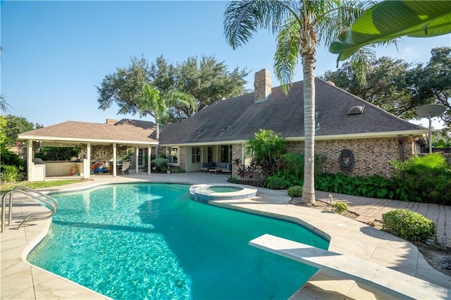 view of pool featuring a diving board, an in ground hot tub, and a patio