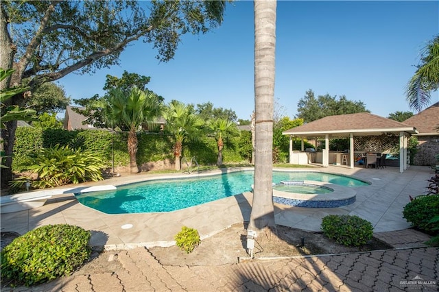 view of swimming pool featuring a gazebo, a diving board, an in ground hot tub, and a patio