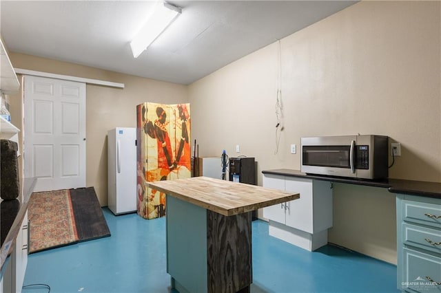 kitchen featuring butcher block counters and white fridge