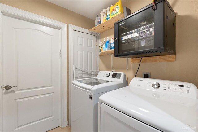 clothes washing area featuring independent washer and dryer