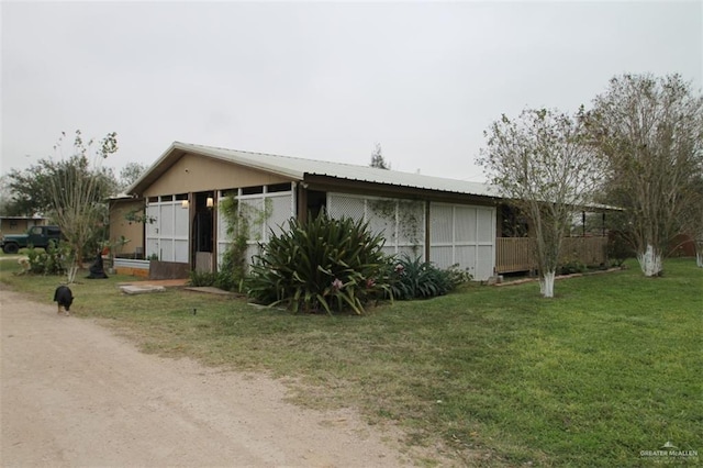 view of side of home with a lawn