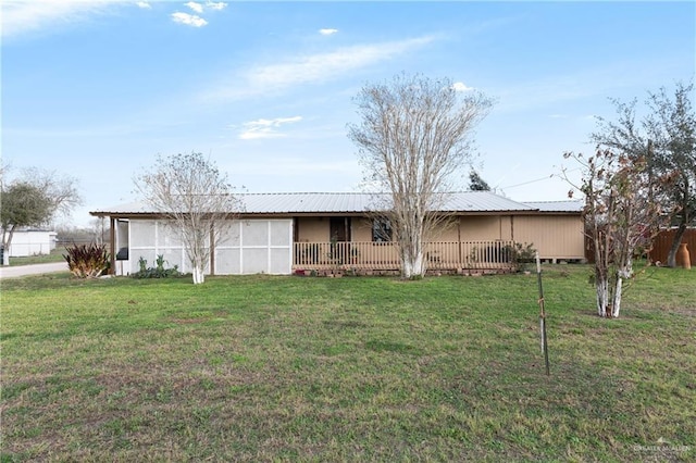 rear view of property featuring a lawn