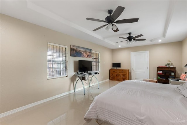 bedroom featuring a tray ceiling and ceiling fan