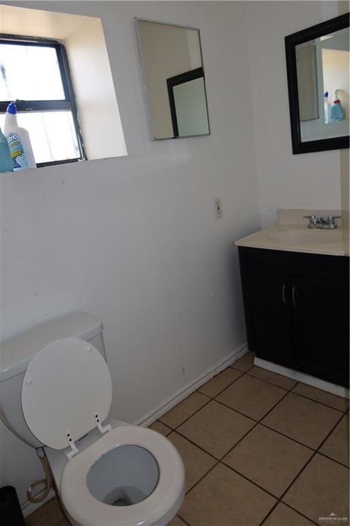 116 N Kansas Ave, Weslaco, TX 78596 - bathroom with toilet, vanity, and tile patterned flooring