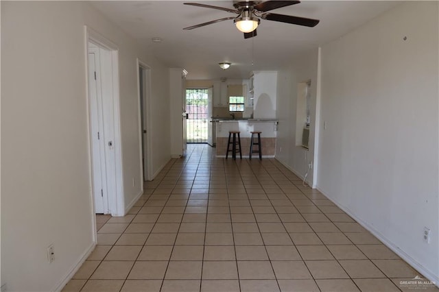 116 N Kansas Ave, Weslaco, TX 78596 - hallway featuring light tile patterned floors and baseboards