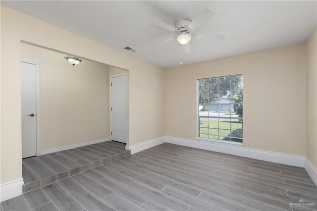 spare room featuring ceiling fan and light hardwood / wood-style flooring