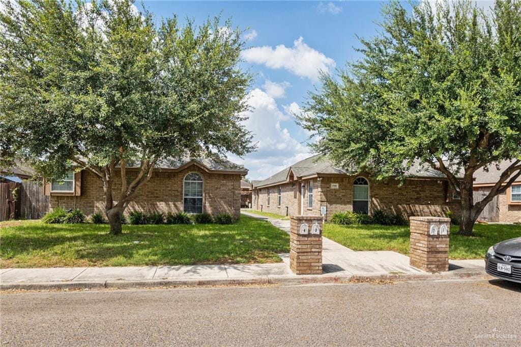 3709 W Faith Hill St, Edinburg, TX 78541 - view of front of home with a front yard and brick siding