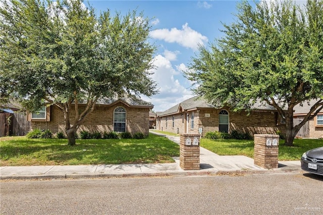 3709 W Faith Hill St, Edinburg, TX 78541 - view of front of home with a front yard and brick siding