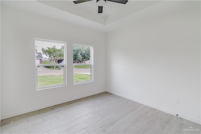 710 W Juarez Ave, Pharr, TX 78577 - spare room with light wood finished floors, a ceiling fan, baseboards, and a raised ceiling
