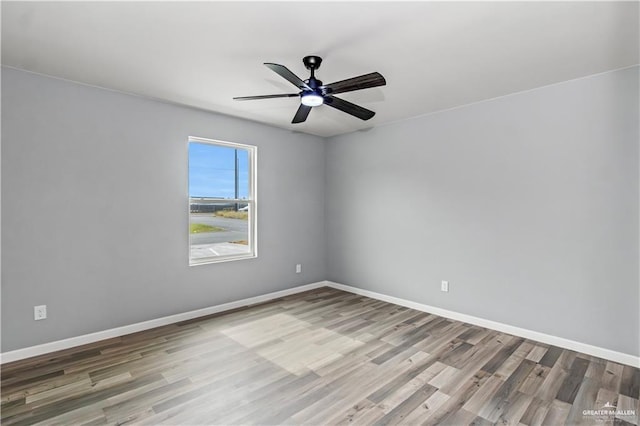 empty room with hardwood / wood-style flooring and ceiling fan