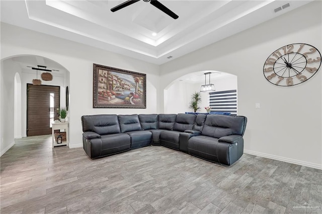 308 N Holland Ave, Mission, TX 78572 - living room with arched walkways, ceiling fan, a raised ceiling, and wood finished floors