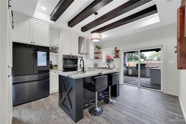 308 N Holland Ave, Mission, TX 78572 - kitchen with smart refrigerator, open shelves, double oven, wall chimney range hood, and white cabinetry