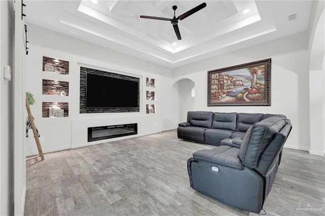 308 N Holland Ave, Mission, TX 78572 - living area featuring a ceiling fan, a raised ceiling, arched walkways, wood finished floors, and recessed lighting