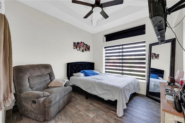 308 N Holland Ave, Mission, TX 78572 - bedroom featuring wood finished floors, a ceiling fan, and a raised ceiling