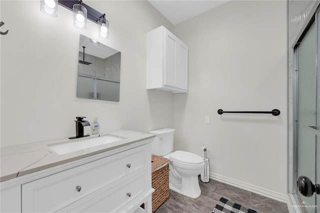 308 N Holland Ave, Mission, TX 78572 - bathroom featuring vanity, a shower with door, and wood finished floors