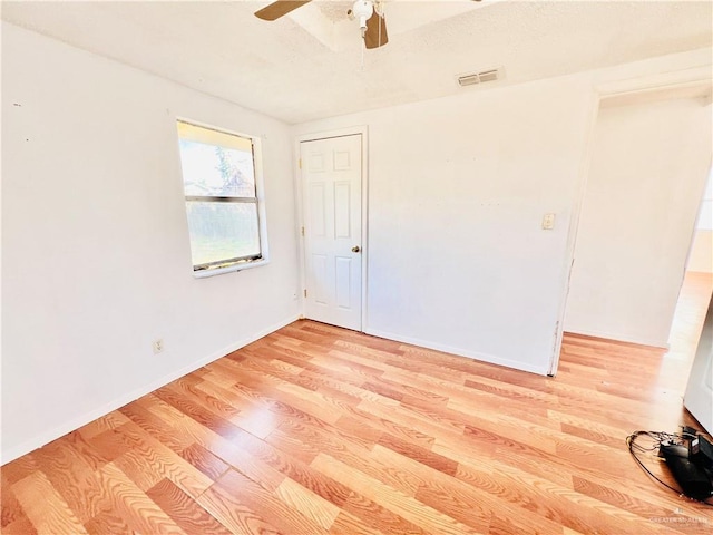 spare room with light hardwood / wood-style floors and ceiling fan