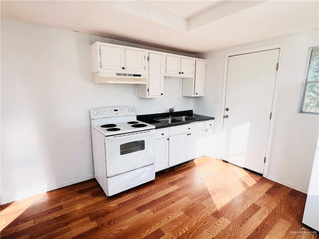 kitchen with white cabinets, sink, hardwood / wood-style flooring, and electric stove