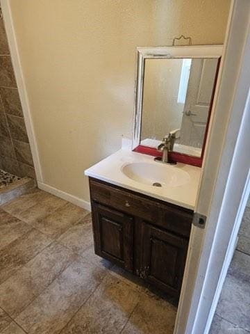 bathroom with tile patterned floors, vanity, and a shower