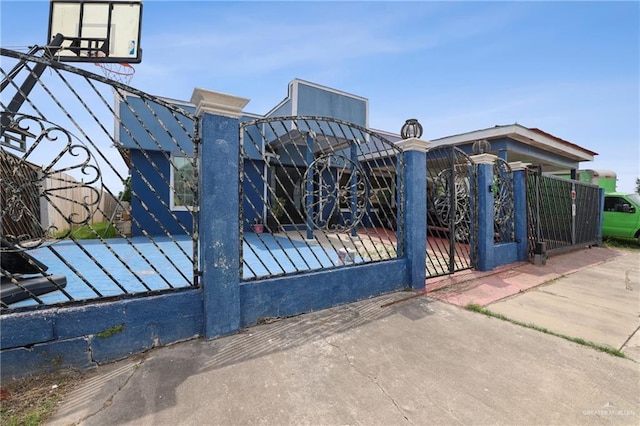 view of gate with a fenced front yard